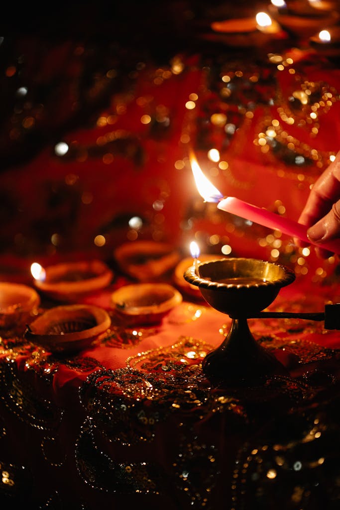 A detailed view of a festive candle setting with warm candlelight and intricate details.
