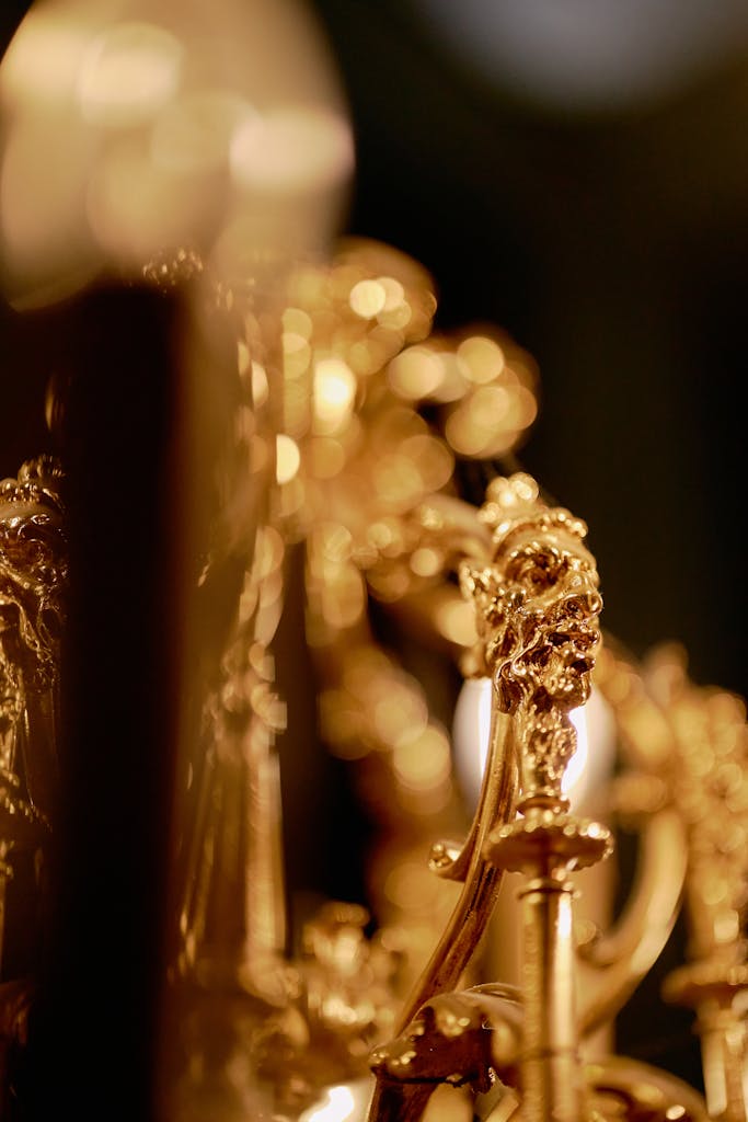 Luxurious ornate gold chandelier close-up showcasing intricate details and soft bokeh